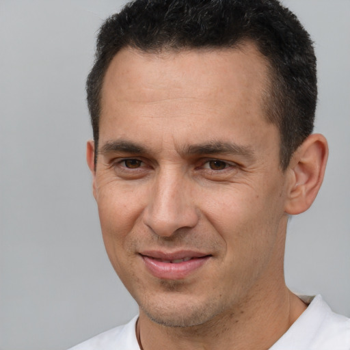 Joyful white adult male with short  brown hair and brown eyes