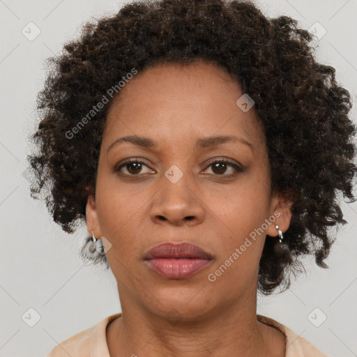 Joyful black adult female with short  brown hair and brown eyes