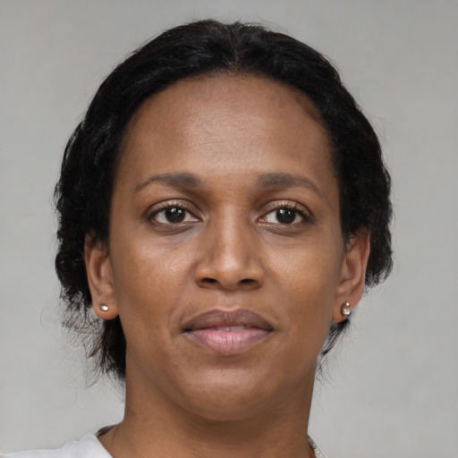 Joyful black adult female with medium  brown hair and brown eyes