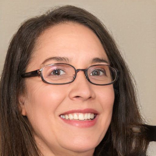 Joyful white adult female with long  brown hair and brown eyes