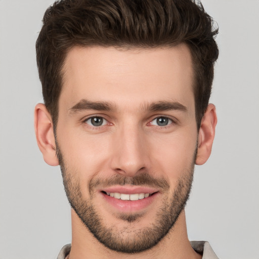 Joyful white young-adult male with short  brown hair and brown eyes