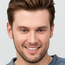 Joyful white young-adult male with short  brown hair and grey eyes