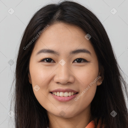 Joyful latino young-adult female with long  brown hair and brown eyes