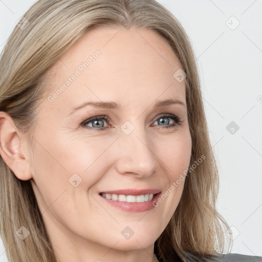 Joyful white young-adult female with long  brown hair and blue eyes