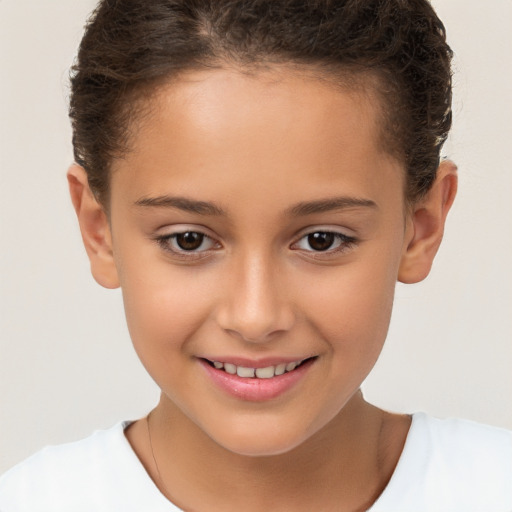 Joyful white child female with short  brown hair and brown eyes