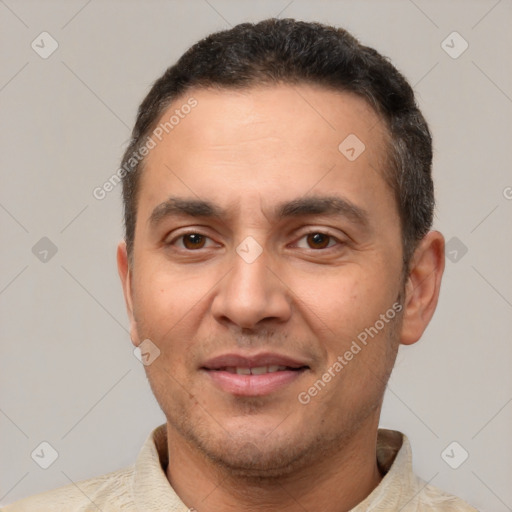 Joyful white adult male with short  black hair and brown eyes