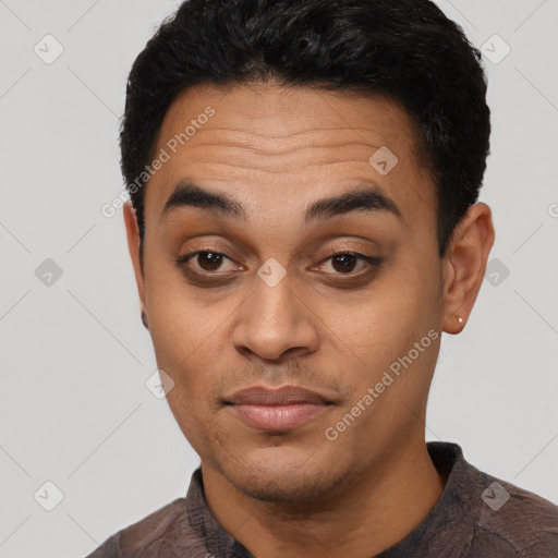 Joyful latino young-adult male with short  black hair and brown eyes