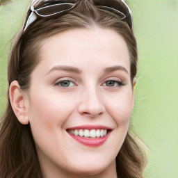 Joyful white young-adult female with long  brown hair and blue eyes