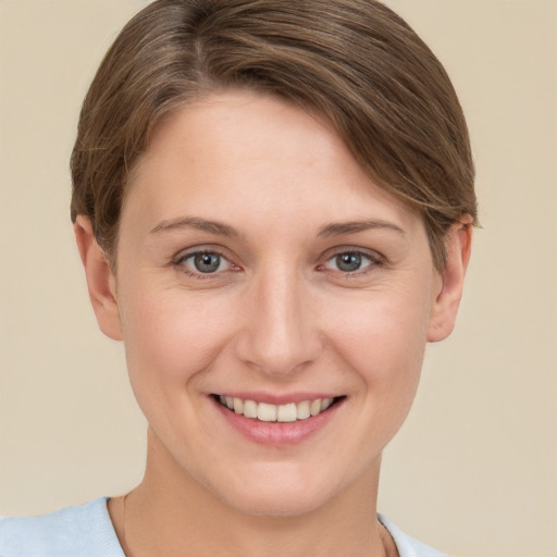 Joyful white young-adult female with short  brown hair and grey eyes