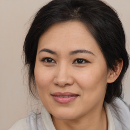 Joyful asian young-adult female with medium  brown hair and brown eyes