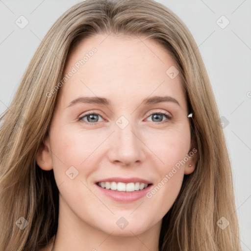 Joyful white young-adult female with long  brown hair and grey eyes