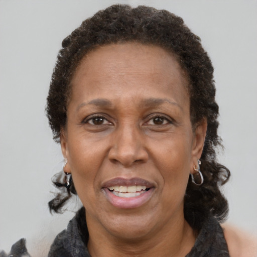 Joyful latino adult female with short  brown hair and brown eyes