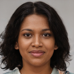 Joyful black young-adult female with medium  brown hair and brown eyes