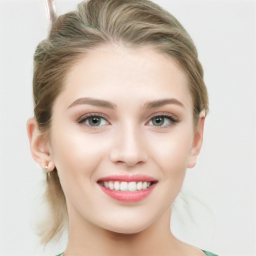 Joyful white young-adult female with medium  brown hair and green eyes