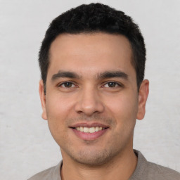Joyful white young-adult male with short  black hair and brown eyes