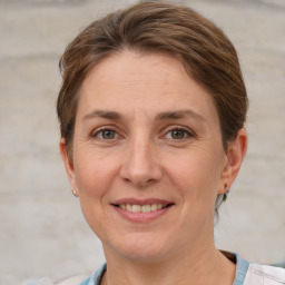 Joyful white adult female with short  brown hair and grey eyes