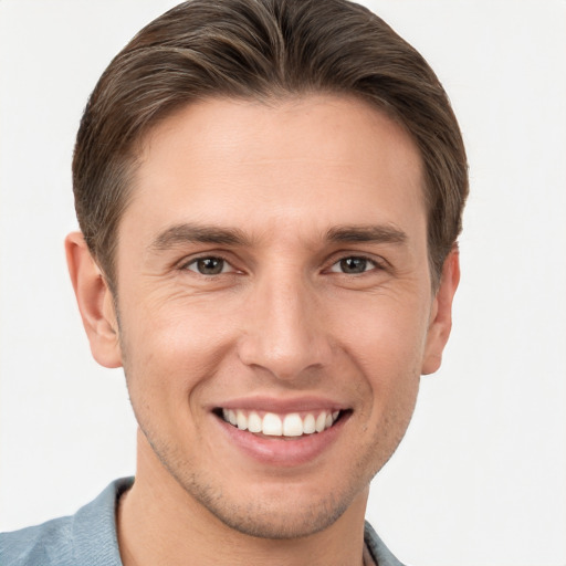 Joyful white young-adult male with short  brown hair and brown eyes