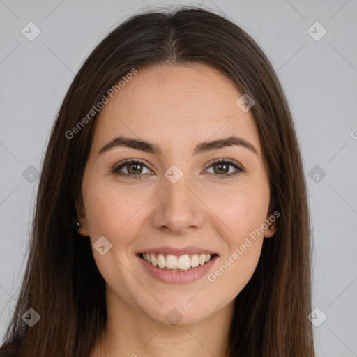 Joyful white young-adult female with long  brown hair and brown eyes