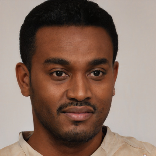 Joyful black young-adult male with short  black hair and brown eyes