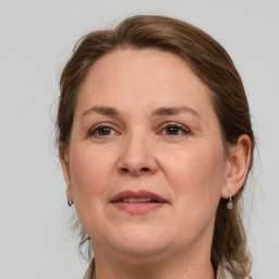 Joyful white adult female with medium  brown hair and grey eyes