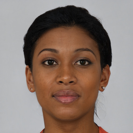 Joyful black young-adult female with short  brown hair and brown eyes