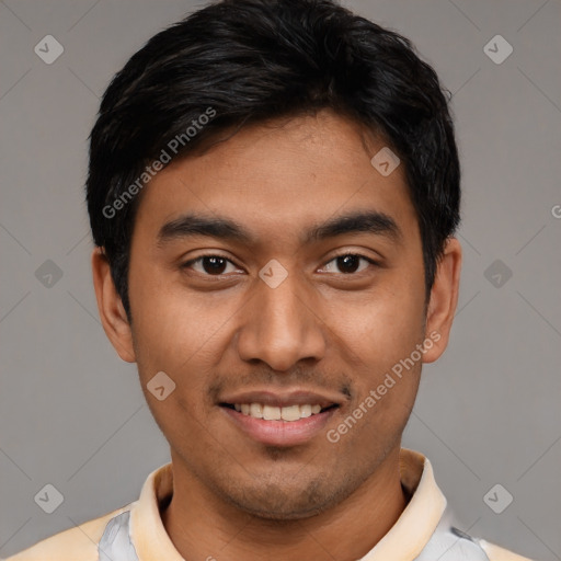 Joyful latino young-adult male with short  black hair and brown eyes