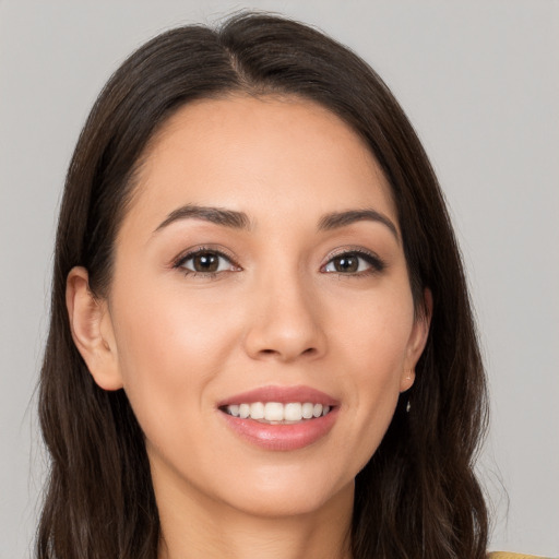 Joyful white young-adult female with long  brown hair and brown eyes