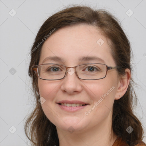 Joyful white adult female with long  brown hair and grey eyes