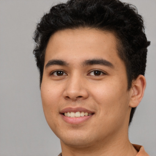 Joyful latino young-adult male with short  black hair and brown eyes