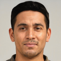 Joyful white young-adult male with short  black hair and brown eyes