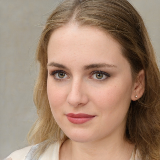 Joyful white young-adult female with medium  brown hair and green eyes