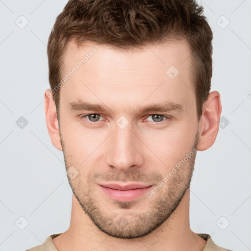 Joyful white young-adult male with short  brown hair and grey eyes