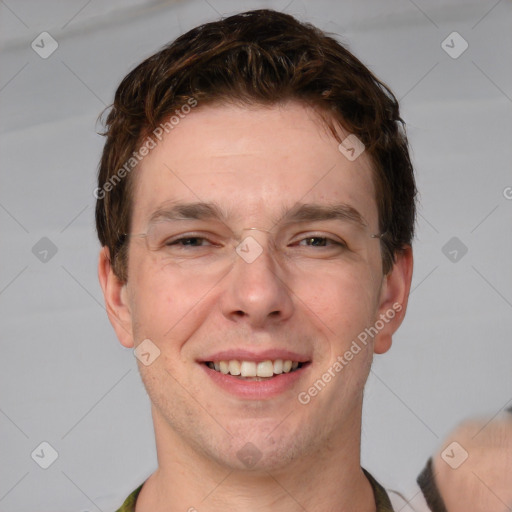 Joyful white adult male with short  brown hair and grey eyes