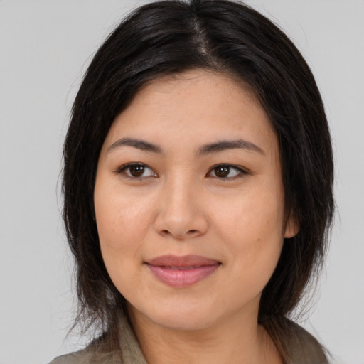 Joyful asian young-adult female with long  brown hair and brown eyes