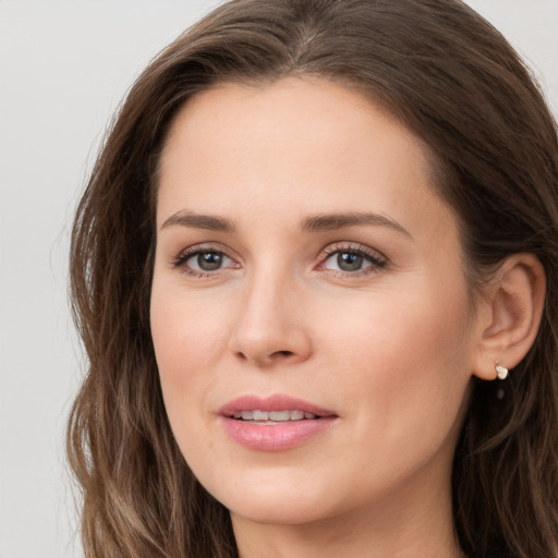 Joyful white young-adult female with long  brown hair and grey eyes