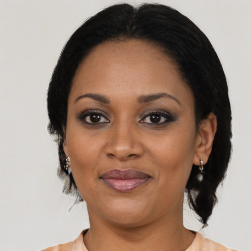 Joyful black adult female with medium  black hair and brown eyes