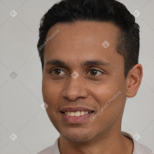 Joyful latino young-adult male with short  brown hair and brown eyes