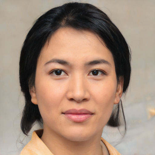 Joyful asian young-adult female with medium  black hair and brown eyes