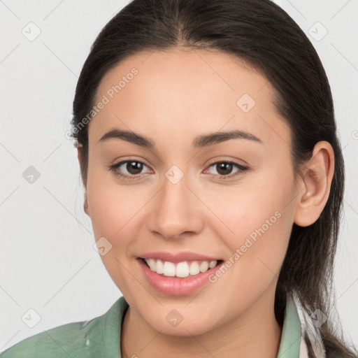 Joyful white young-adult female with long  brown hair and brown eyes