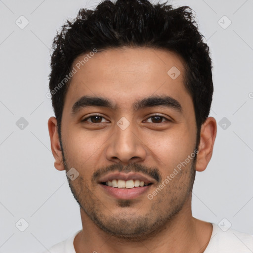 Joyful latino young-adult male with short  black hair and brown eyes