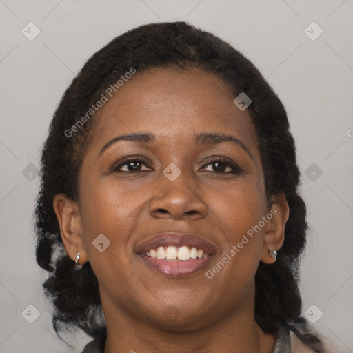 Joyful black young-adult female with medium  brown hair and brown eyes