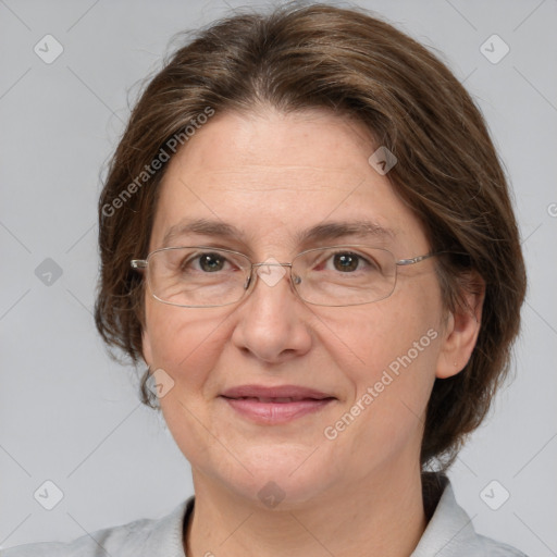 Joyful white adult female with medium  brown hair and grey eyes