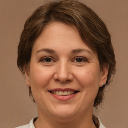 Joyful white adult female with medium  brown hair and brown eyes