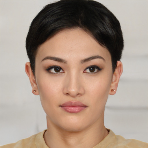 Joyful asian young-adult female with short  brown hair and brown eyes