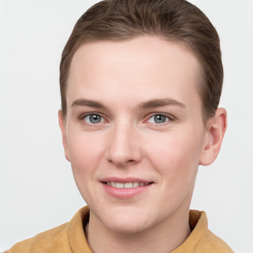 Joyful white young-adult female with short  brown hair and grey eyes