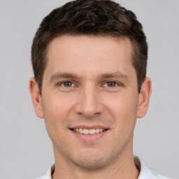 Joyful white young-adult male with short  brown hair and brown eyes