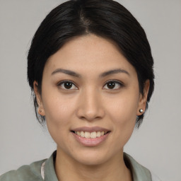 Joyful asian young-adult female with medium  brown hair and brown eyes