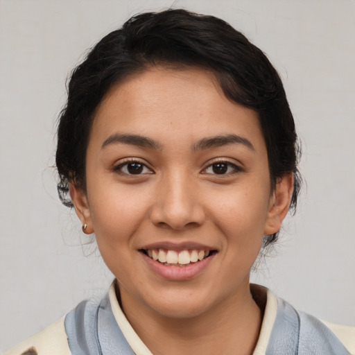Joyful latino young-adult female with medium  black hair and brown eyes