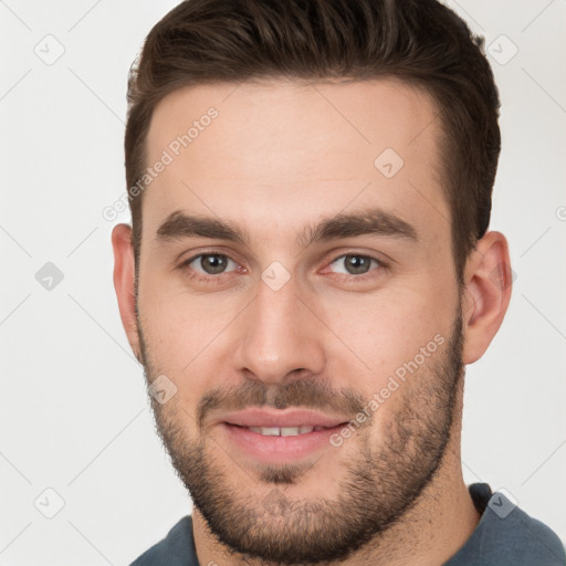 Joyful white young-adult male with short  brown hair and brown eyes