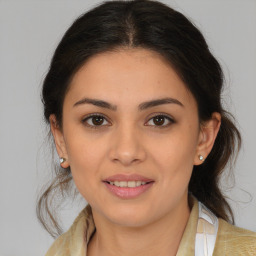 Joyful latino young-adult female with medium  brown hair and brown eyes